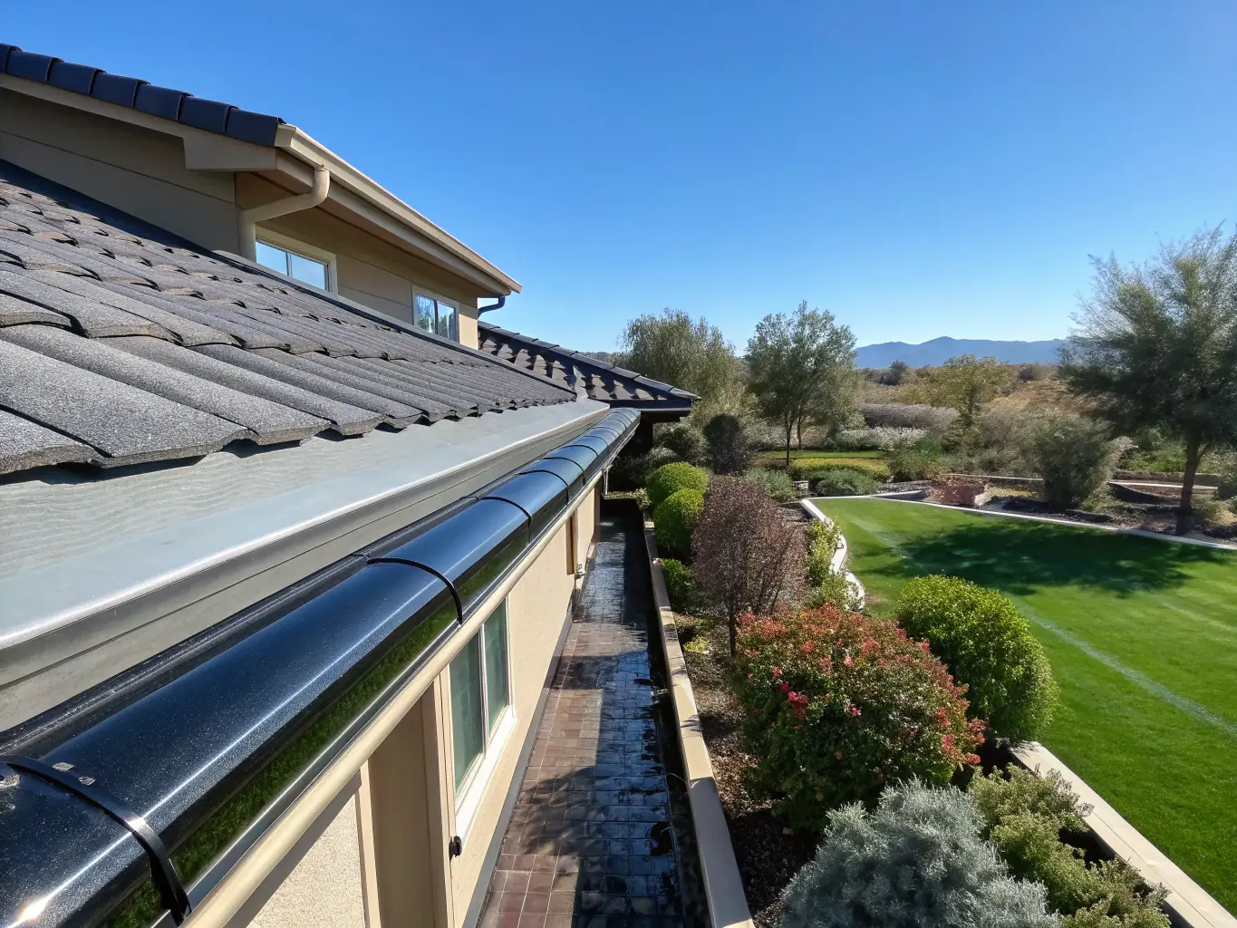 A clean, well-maintained gutter system on a single-story home, showcasing effective water drainage and a tidy exterior.